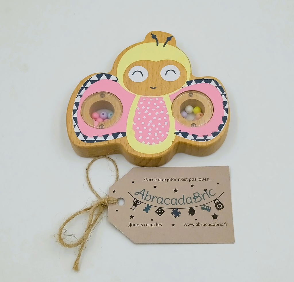 Hochet papillon en bois à billes rose